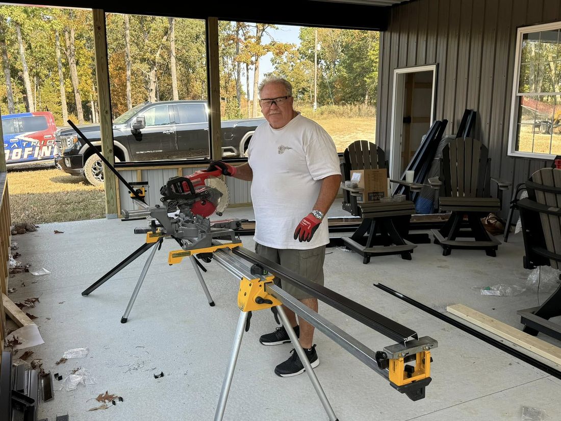 A Patriot Roofing crew member fabricating metal trim on site